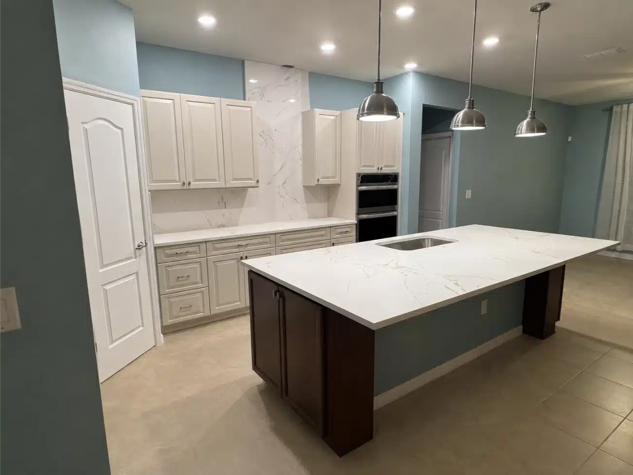 Kitchen after remodeling, showing the simplified backsplash and painted walls