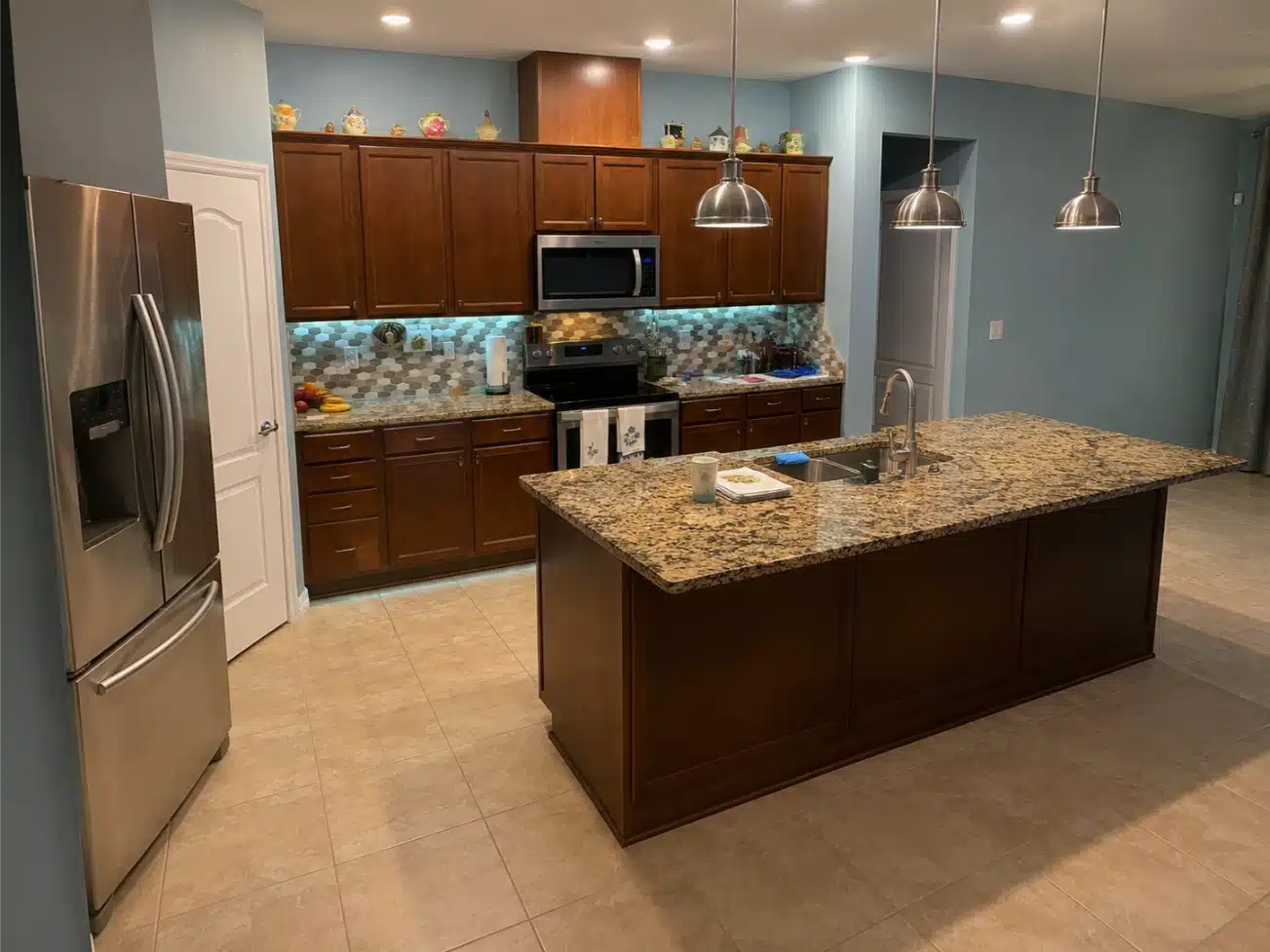 Kitchen before remodeling, showing the mosaic tile backsplash and wall ovens