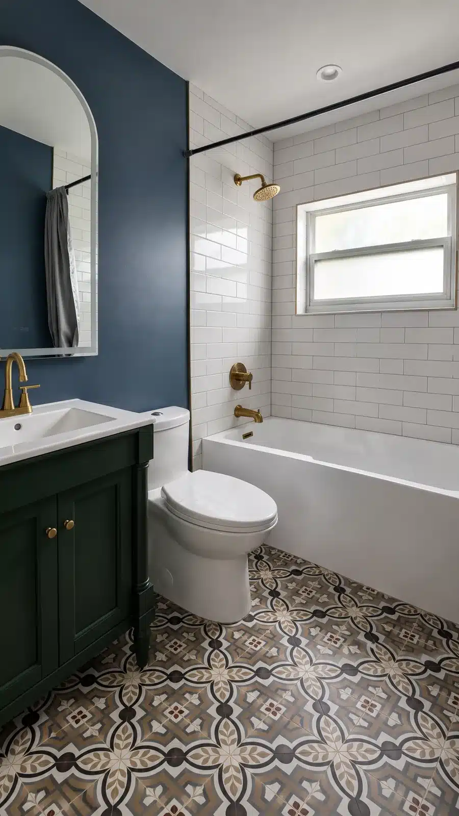 Finished bathroom with a green vanity, arched mirror, patterned floor and tiled tub surround