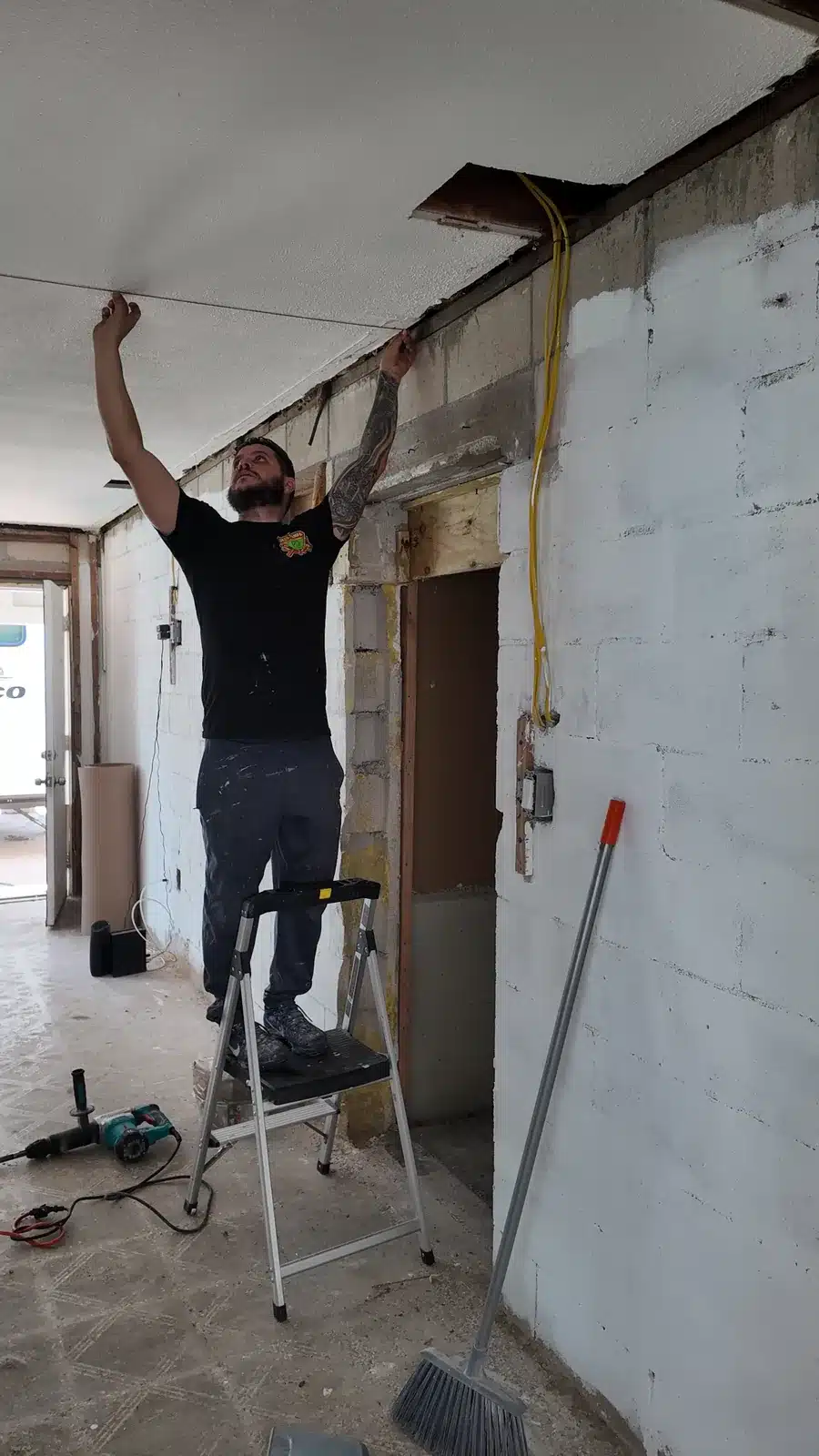 Crew member removing ceiling framing during the New Port Richey strip-out